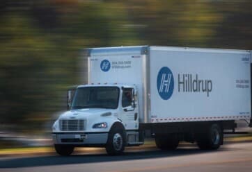 Hilldrup truck driving on road.