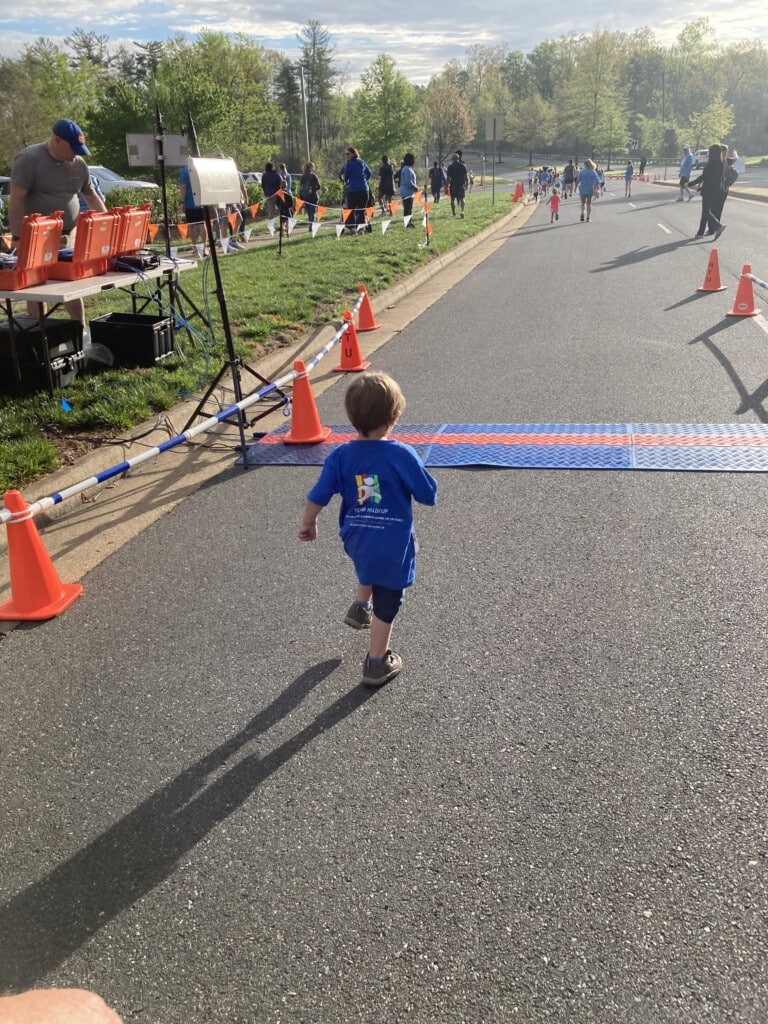 Small child running during Stafford 5K event 