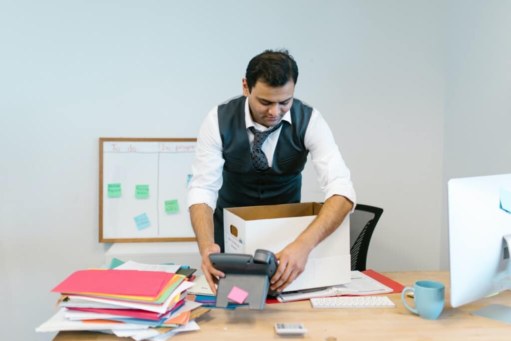 Man packing up office supplies