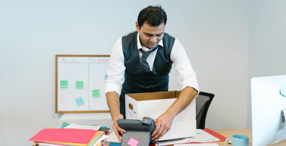 Man packing up office supplies