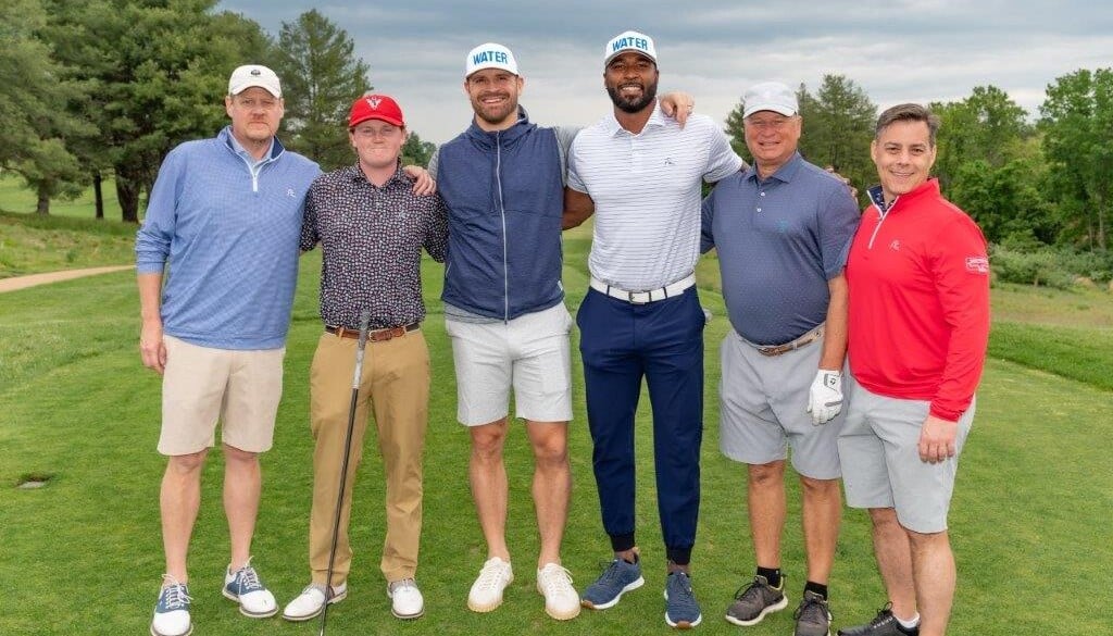 Team Hilldrup with Chris Long and E.J. Manuel on a golf course.