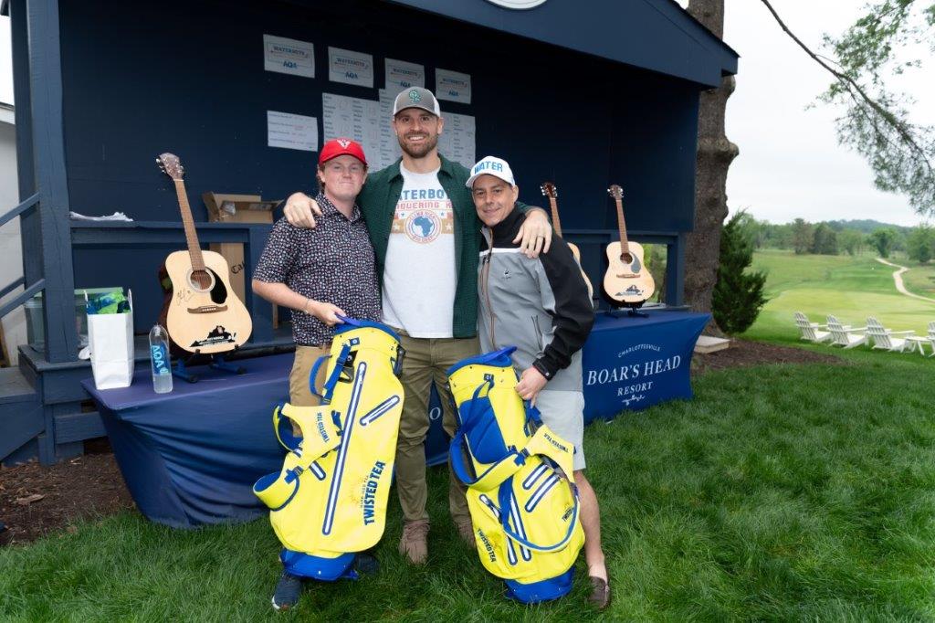 Andrew Watson and Troy Gibson with Chris Long at golf course. 