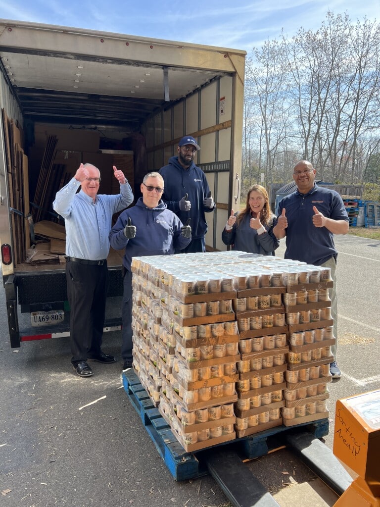 Stafford team works with Giant Food to load cans of food donations. 