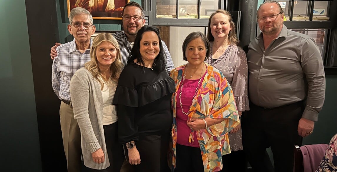 Joyce Lopez with her family during her retirement dinner celebration