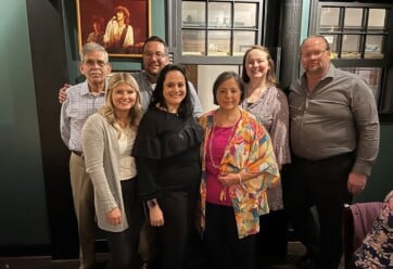 Joyce Lopez with her family during her retirement dinner celebration