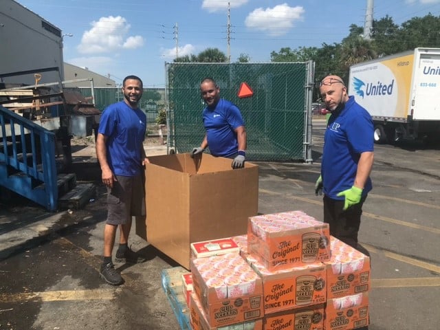 Orlando unloading canned food items to United Against Poverty. 