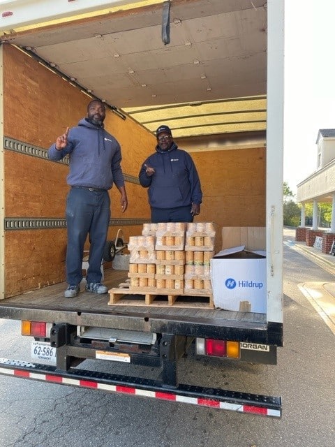 Raleigh-Durham loads canned goods into truck. 