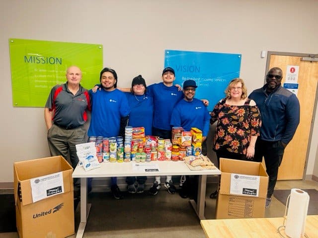 Atlanta with their donations from a food drive. 