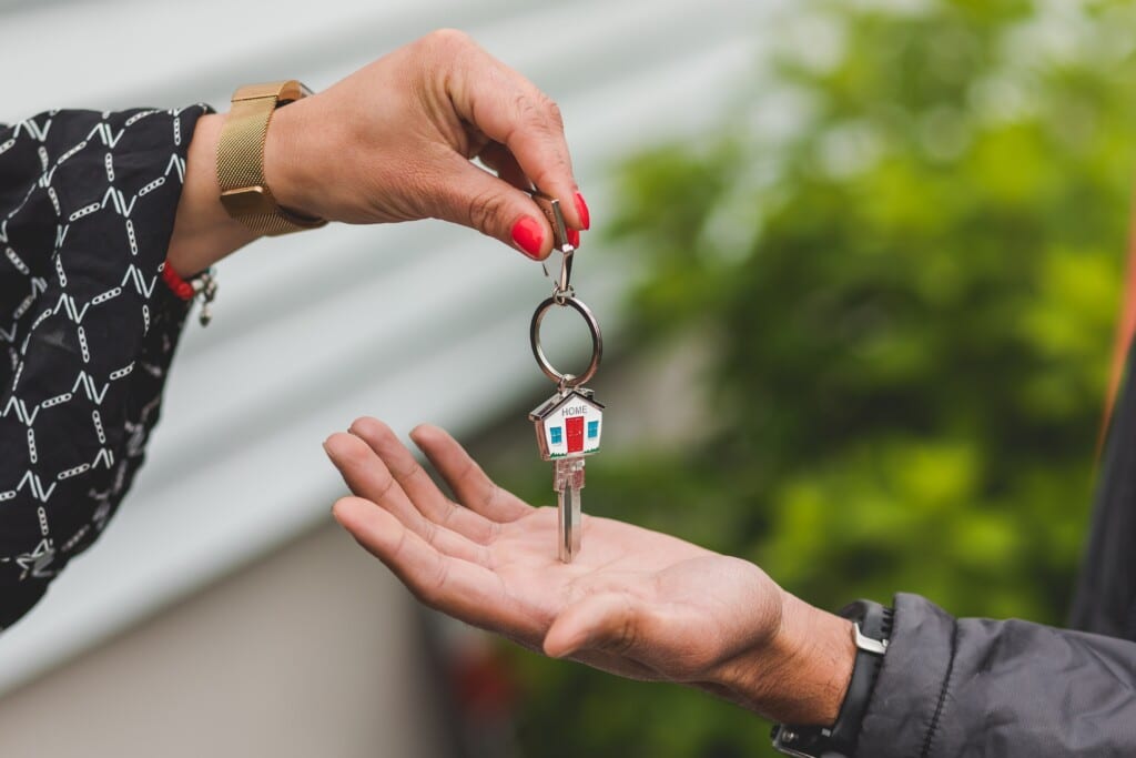 realtor passing the keys of a home to a new homeowner
