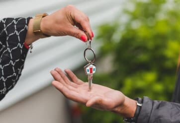 realtor passing the keys of a home to a new homeowner