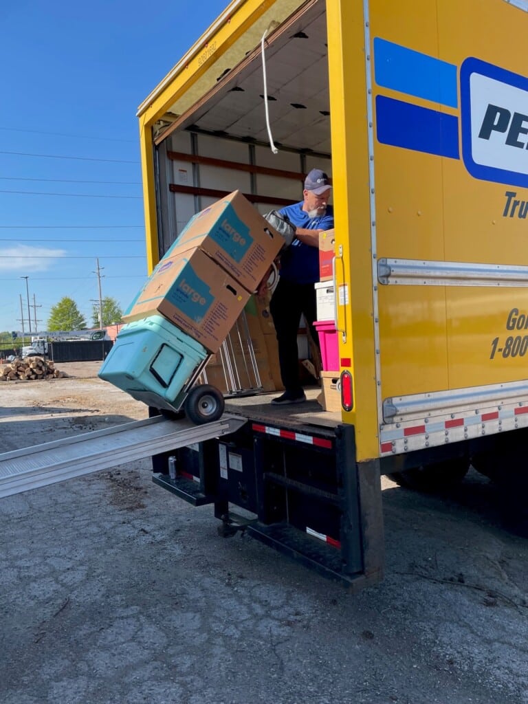 Henry Lewis Kubicek loading household goods into a shuttle truck. 