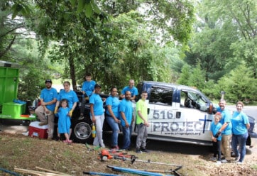 Volunteers with the 516 Project gathered around a worktruck.