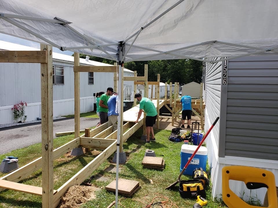Volunteers with the 516 Project help install a handicap ramp to a home in the local area. 