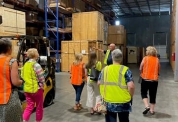 AID Interior Designers touring Raleigh-Durham's warehouse facility.