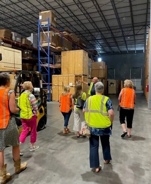 AID Interior Designers touring Raleigh-Durham's warehouse facility.