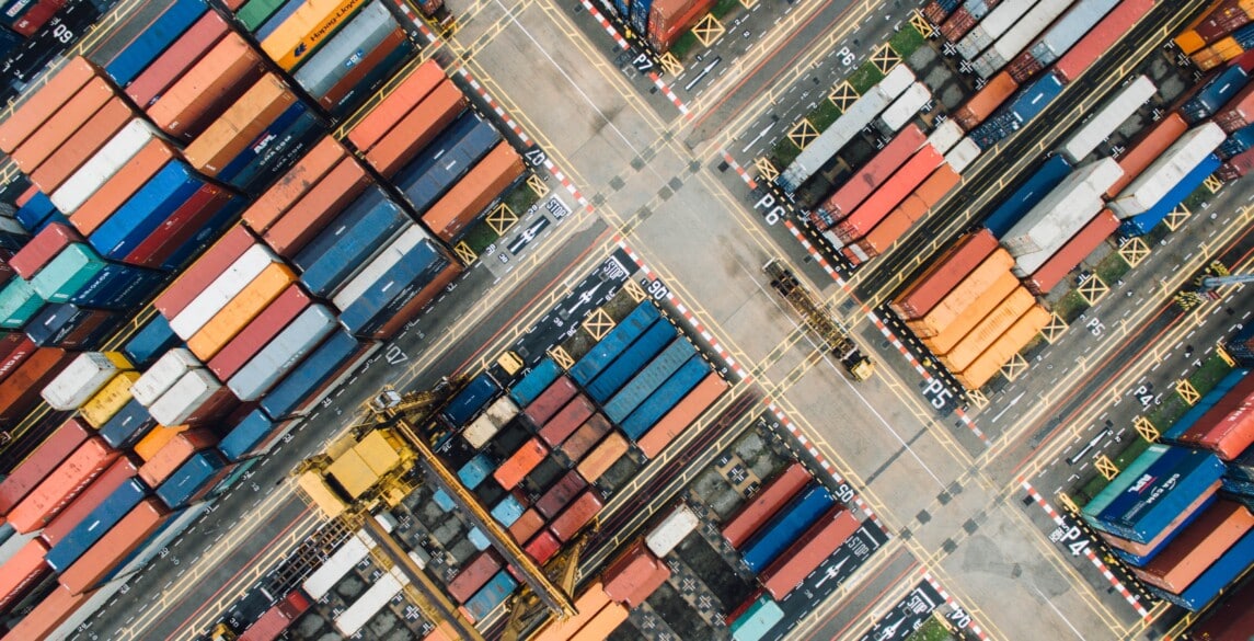 Aerial shot of shipping containers in a shipyard.