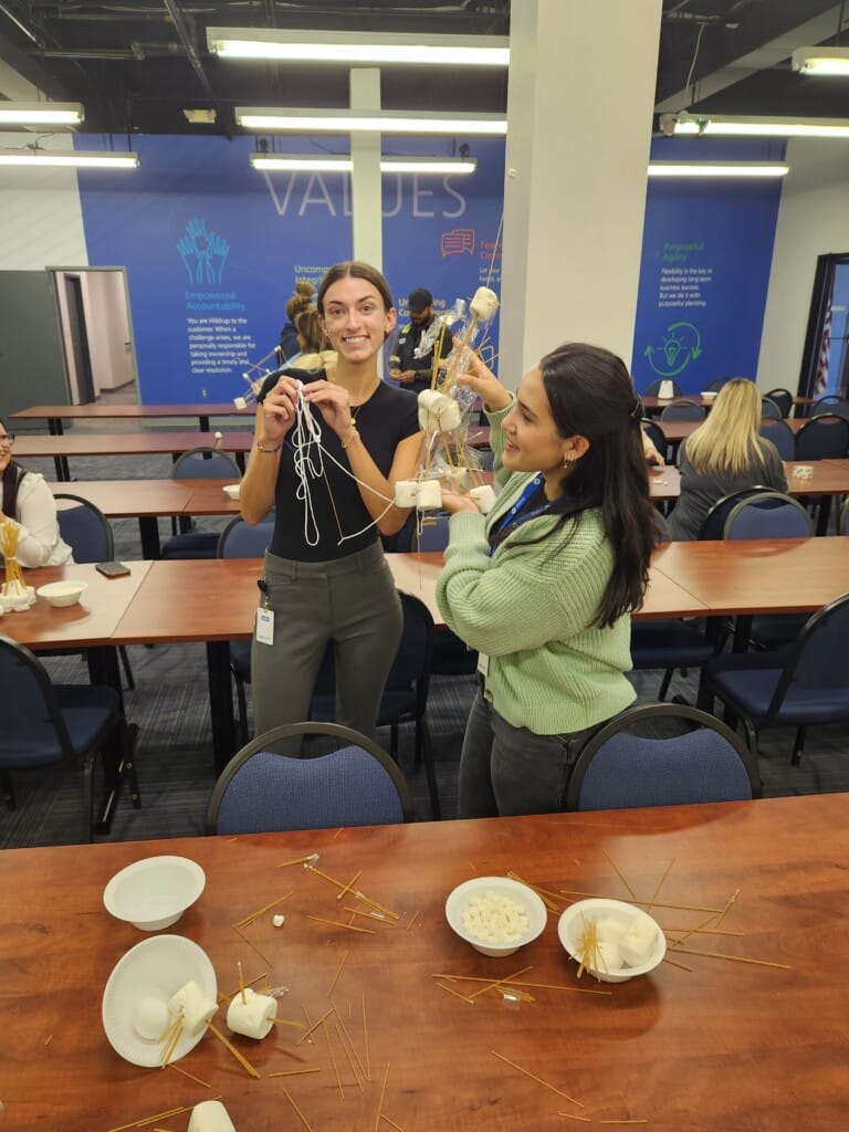 Employees during the RUW kickoff week activity of building a tower. 