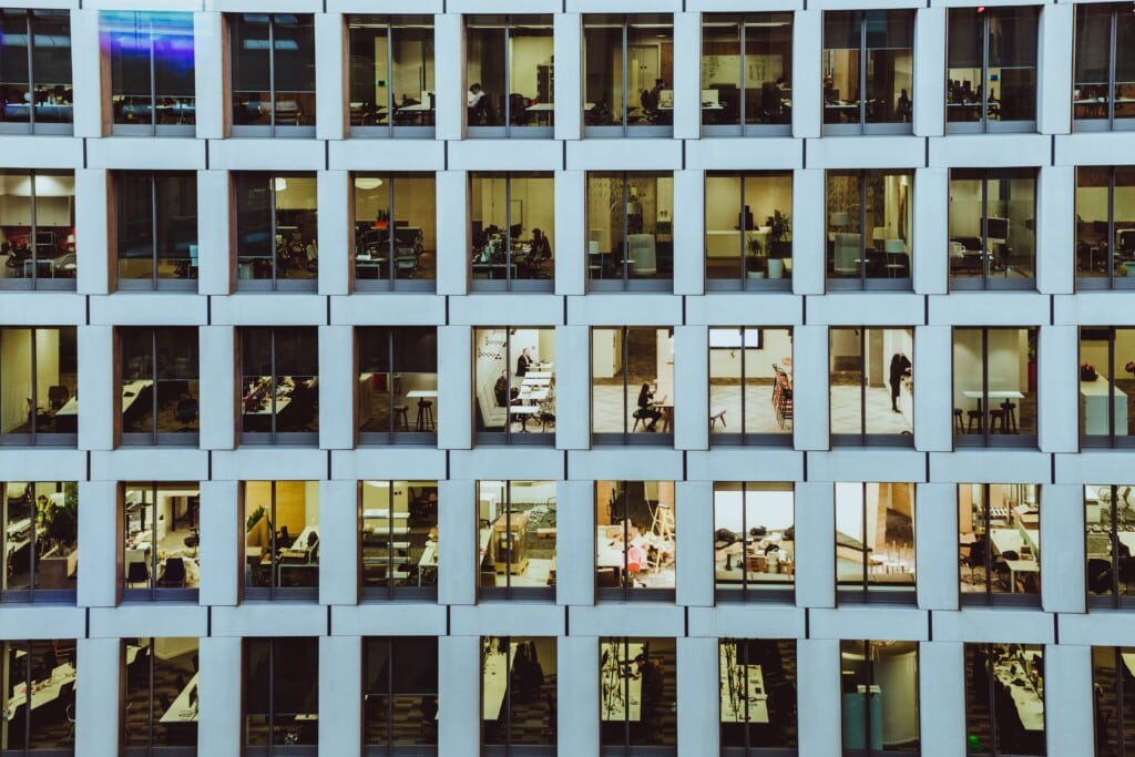 Exterior shot of an office building with many windows.