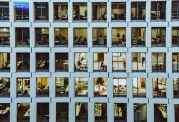 Exterior shot of an office building with many windows.