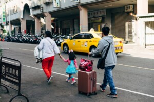 family abroad with suitcases