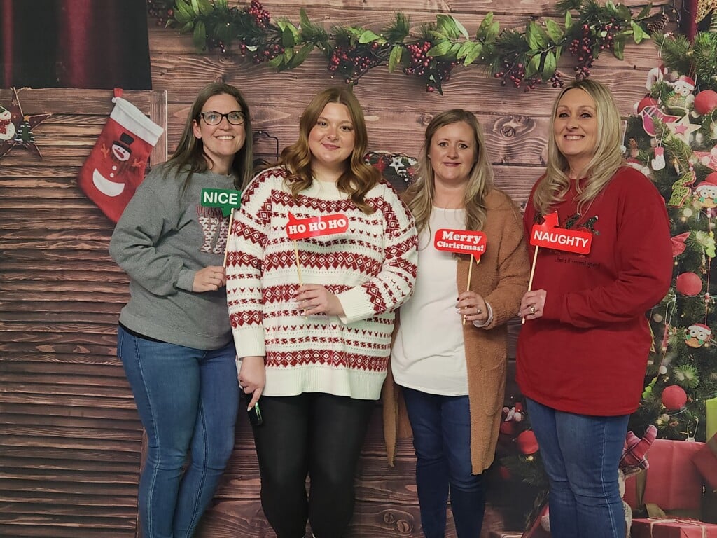 Four of Hilldrup's customer service team members at Stafford's holiday party. 