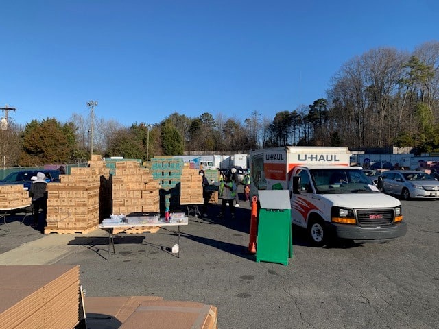 Vehicles loading up Girl Scout cookie cases at Hilldrup Charlotte in 2024. 