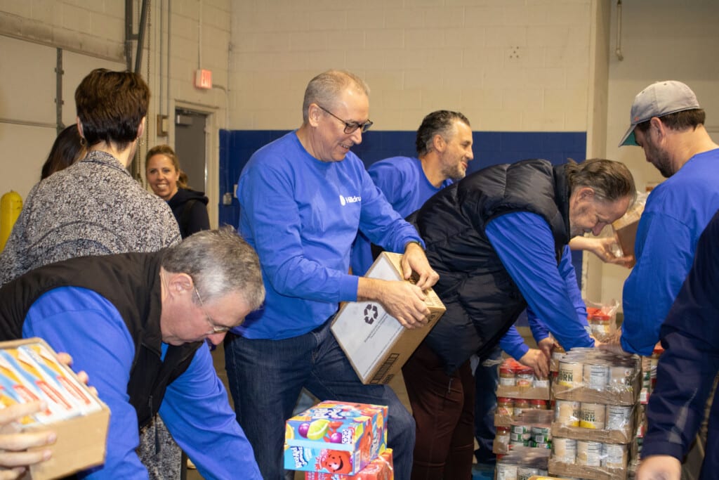 Employees volunteering during the 2024 All Sales Meeting 