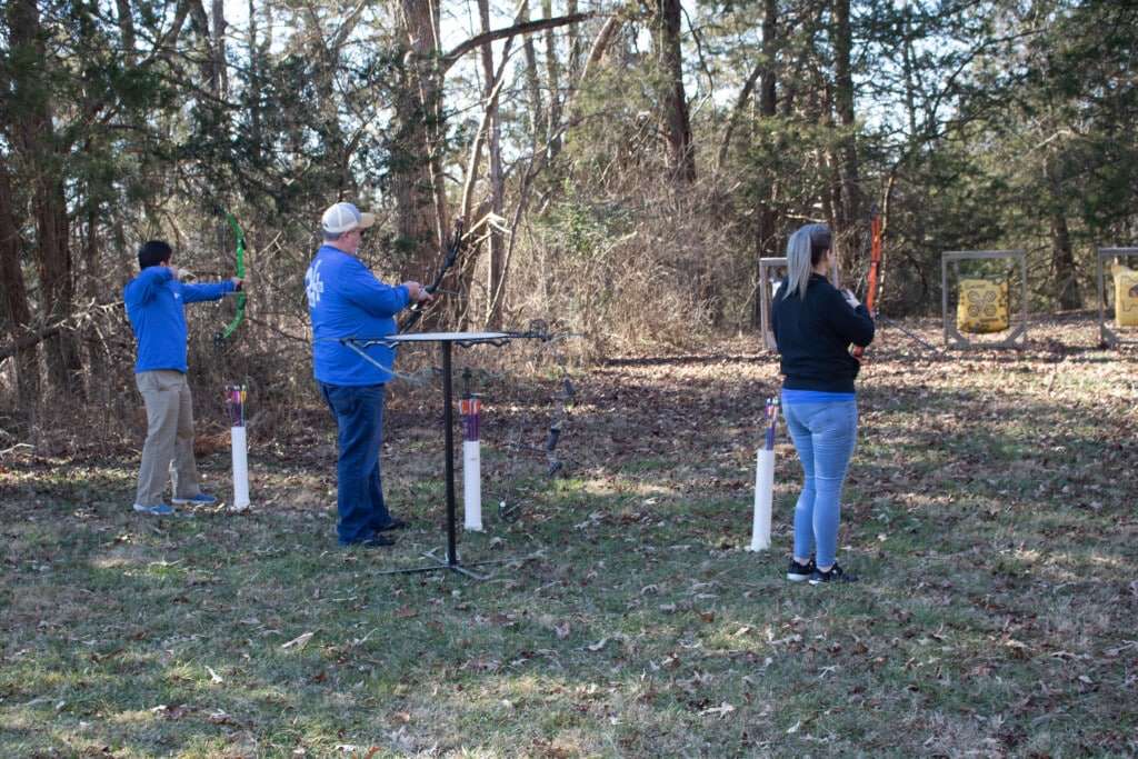 Employees enjoying archery during the 2024 All Sales Meeting event. 