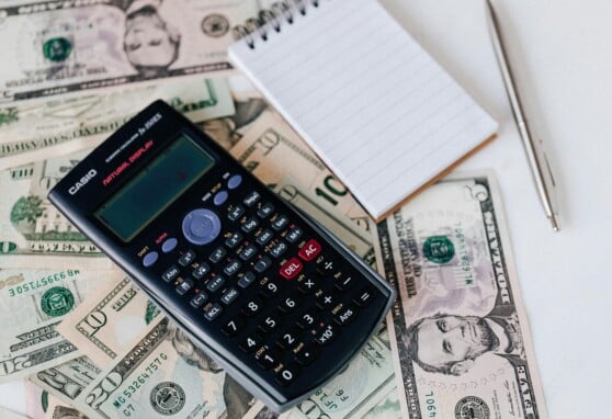 calculator and notepad with cash