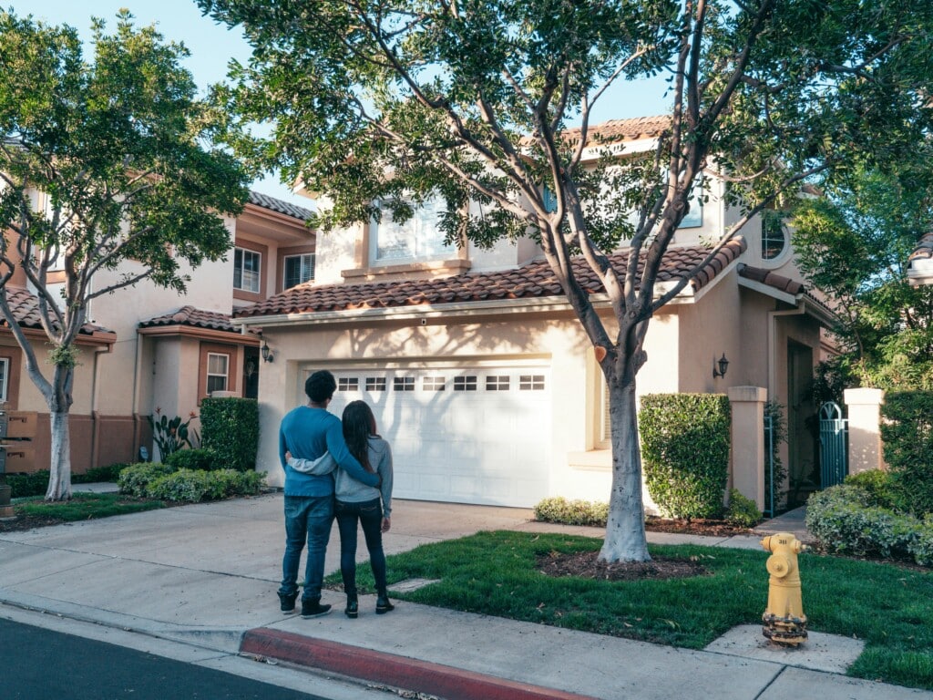 couple outside, looking at new home