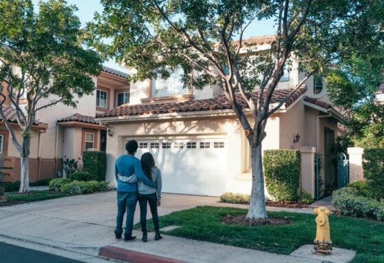 couple outside, looking at new home