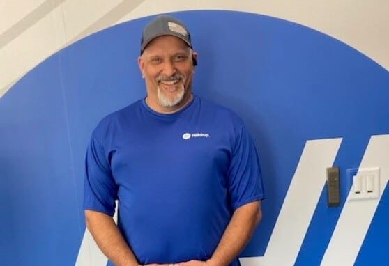 Lonnie Orf in front of Hilldrup logo