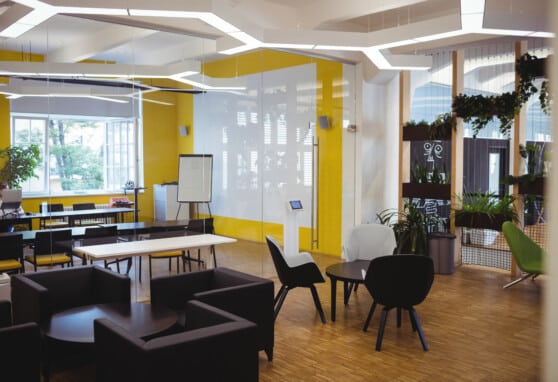 view of empty office with modular furniture and natural light