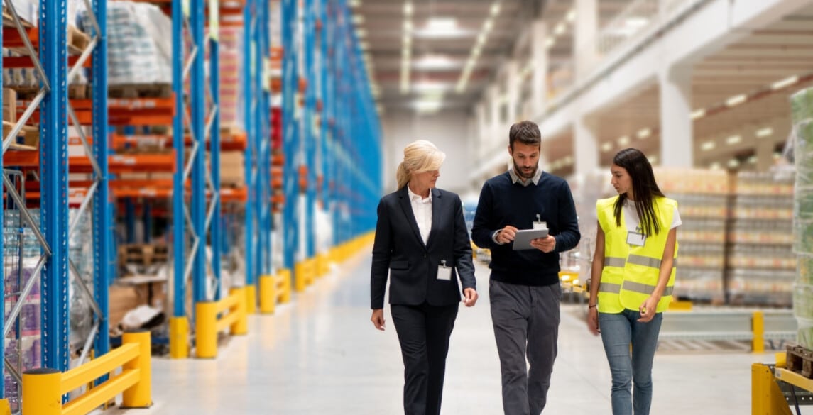 people walking in warehouse, safety vest, logistics