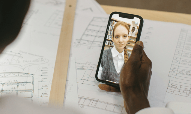 women on video call with architectural drawings in background