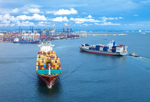 Cargo maritime ship in the ocean carrying containers for export.
