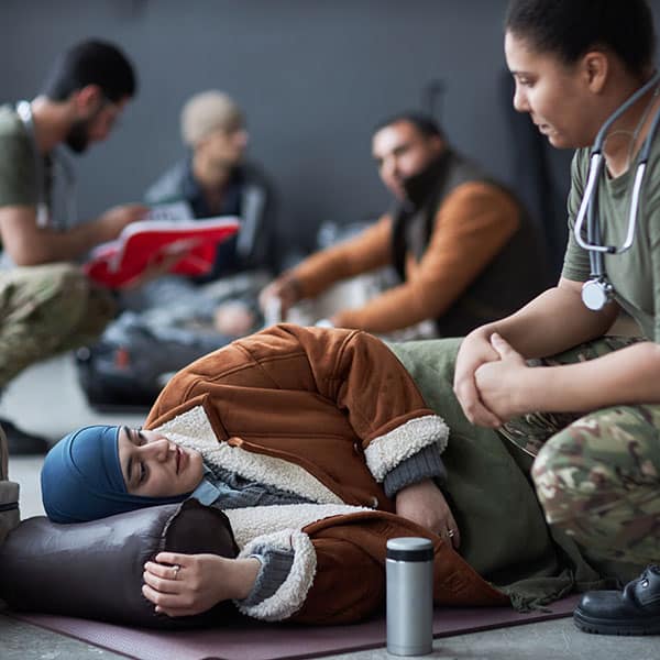 Military doctor caring for aid patient.