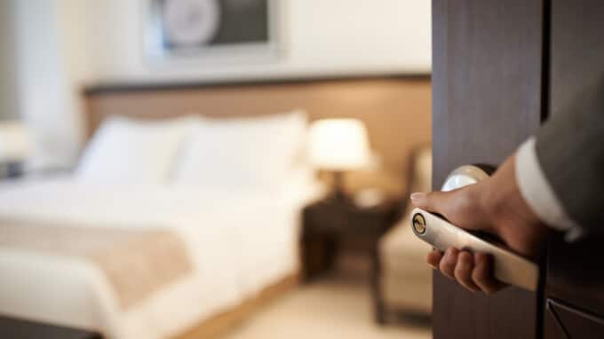 Female hand opening hotel room, selective focus