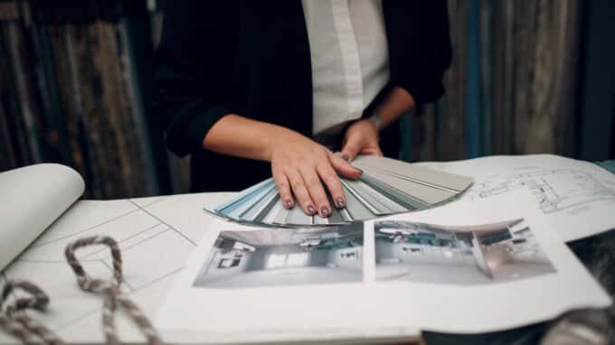 Interior design concept. Designer hands and project.