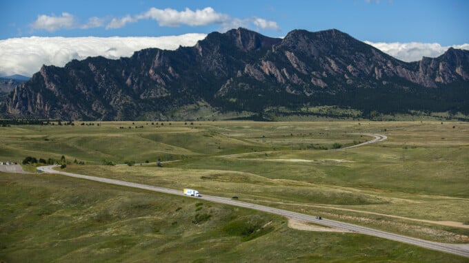 photo of moving truck on a road winding through the mountains