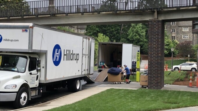 Hilldrup truck with items being moving into a building