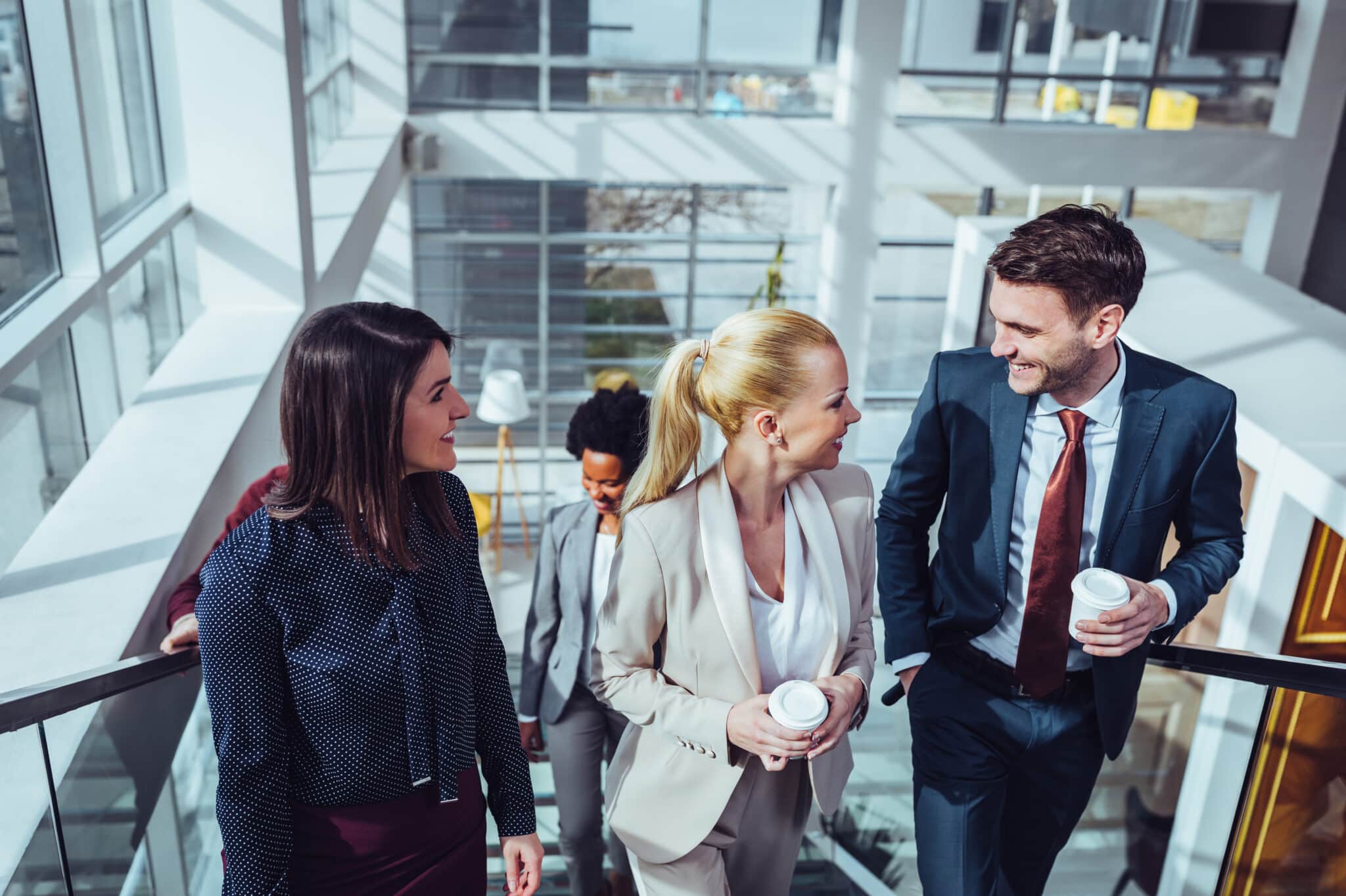 Business colleagues drinking coffee during office break.