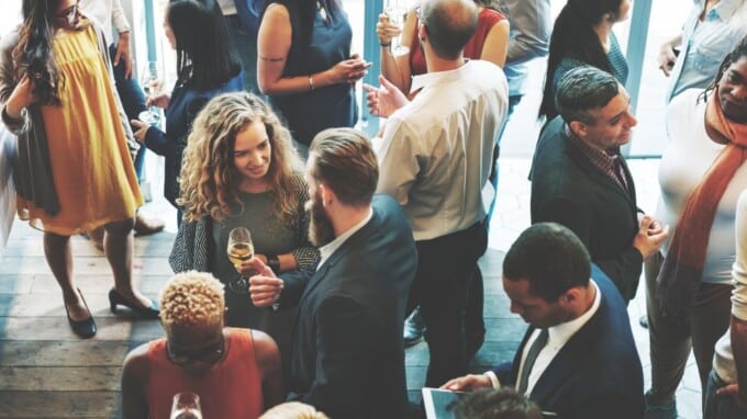 High level view of employees interacting at a company Christmas party.