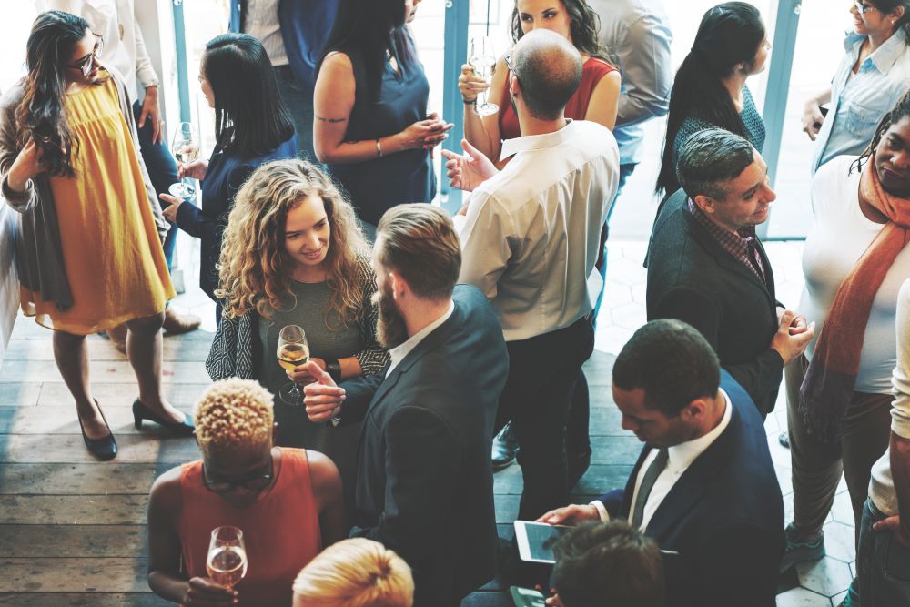 High level view of employees interacting at a company Christmas party.