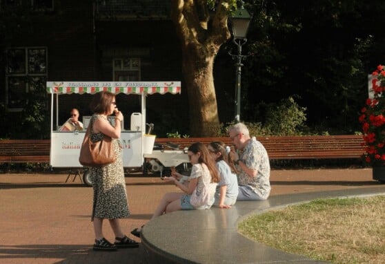 Family stopping to eat a treat outside
