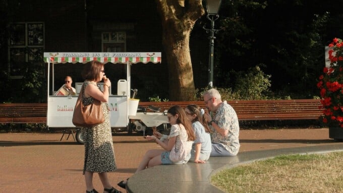 Family stopping to eat a treat outside