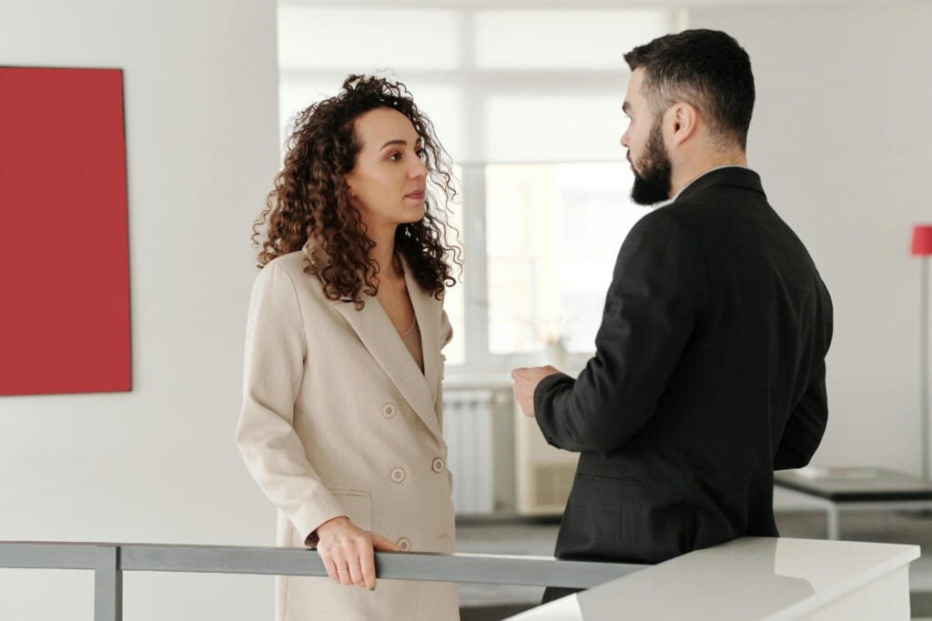A male and female engage in a workplace conversation