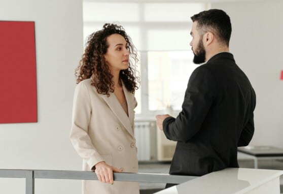 A male and female engage in a workplace conversation