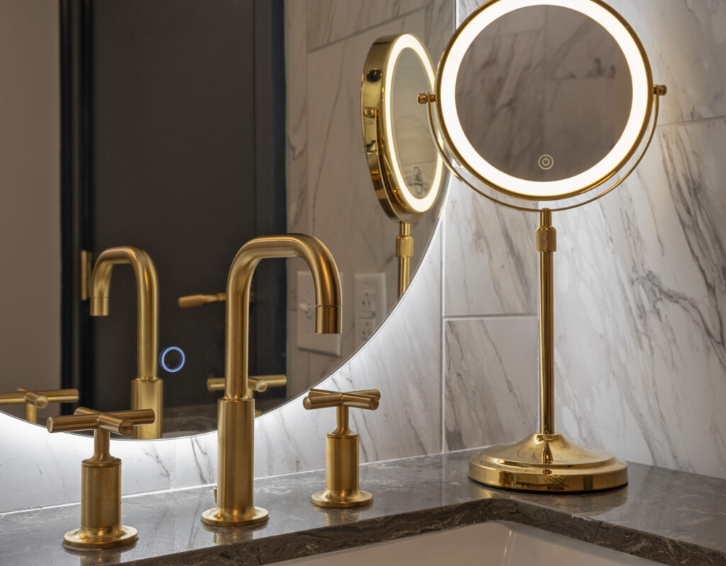 Guestroom vanity with brass fixtures at The Publisher hotel