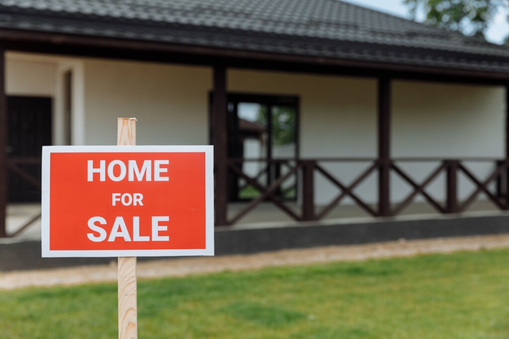 Red sign that says home for sale